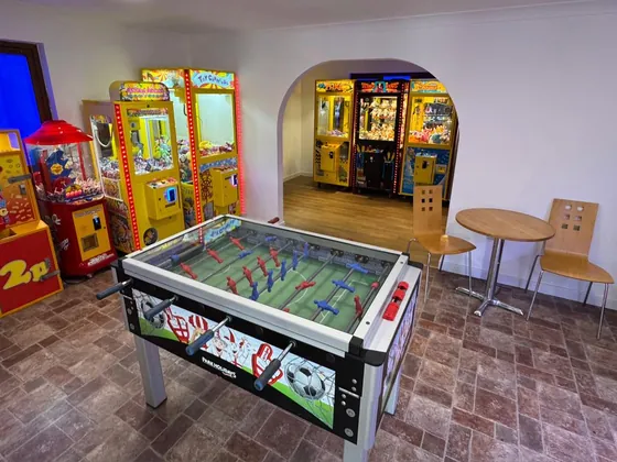 Indoor arcade and games room with table football and amusement machines.