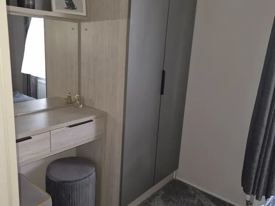 Bedroom wardrobe and dressing table storage space.