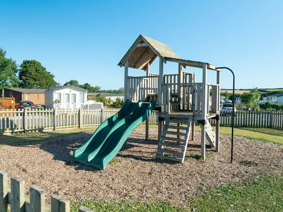 Outdoor children's play area with climbing frame and slides.