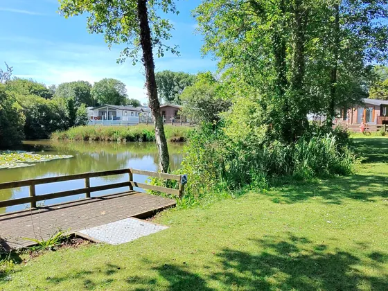 Peaceful lakeside area and green space on the holiday park.