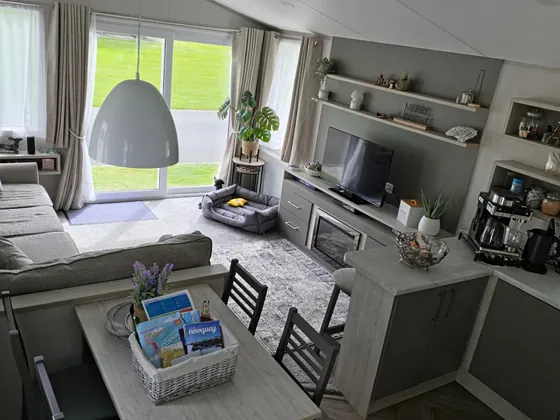 Open-plan dining, lounge and kitchen area inside the holiday home.