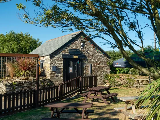 The Piskie Inn, the smallest bar in Crantock, with outdoor seating at the holiday park.
